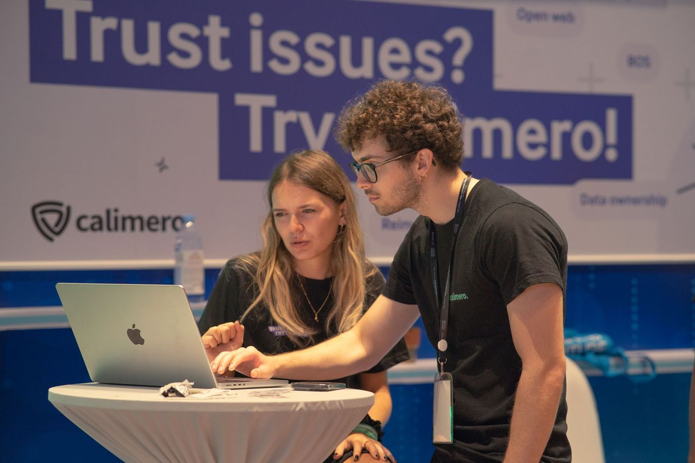 Two exhibitors working at their stand during a business event