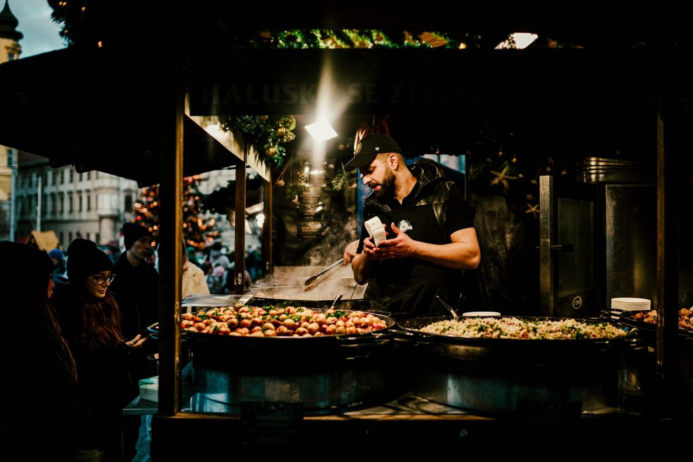 A food stall trading at a lit evening market
